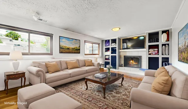 a living room with furniture gym equipment and a large window