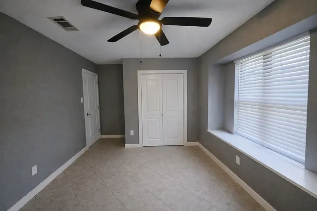 a view of room with window and ceiling fan