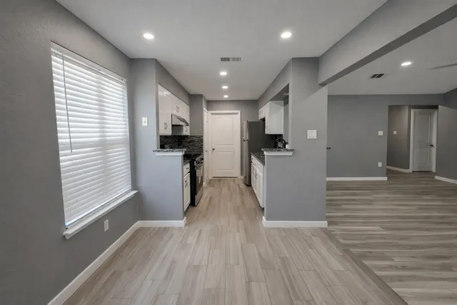 a view of a refrigerator in kitchen and wooden floor