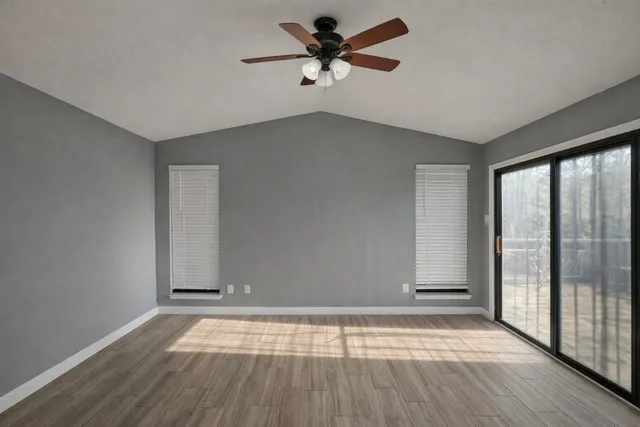 wooden floor in an empty room with a window