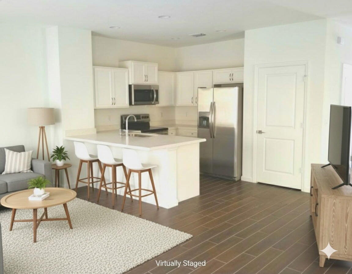 1021 Northwest 40th Terrace Lauderhill, FL 33313 - Photo 3 of 9 a kitchen with stainless steel appliances granite countertop a refrigerator a stove top oven a dining table and chairs with wooden floor