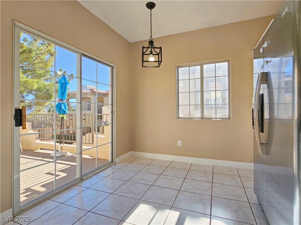1851 Hillpointe Road, Unit 2124 Henderson, NV 89074 - Photo 9 of 24 Unfurnished dining area featuring baseboards and light tile patterned floors