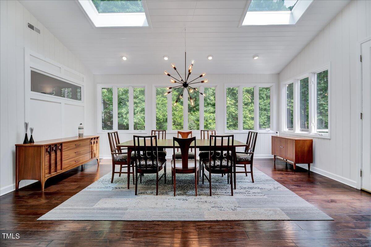 11313 Rumshill Road Raleigh, NC 27614 - Photo 12 of 55 a view of a dining room with furniture window and wooden floor