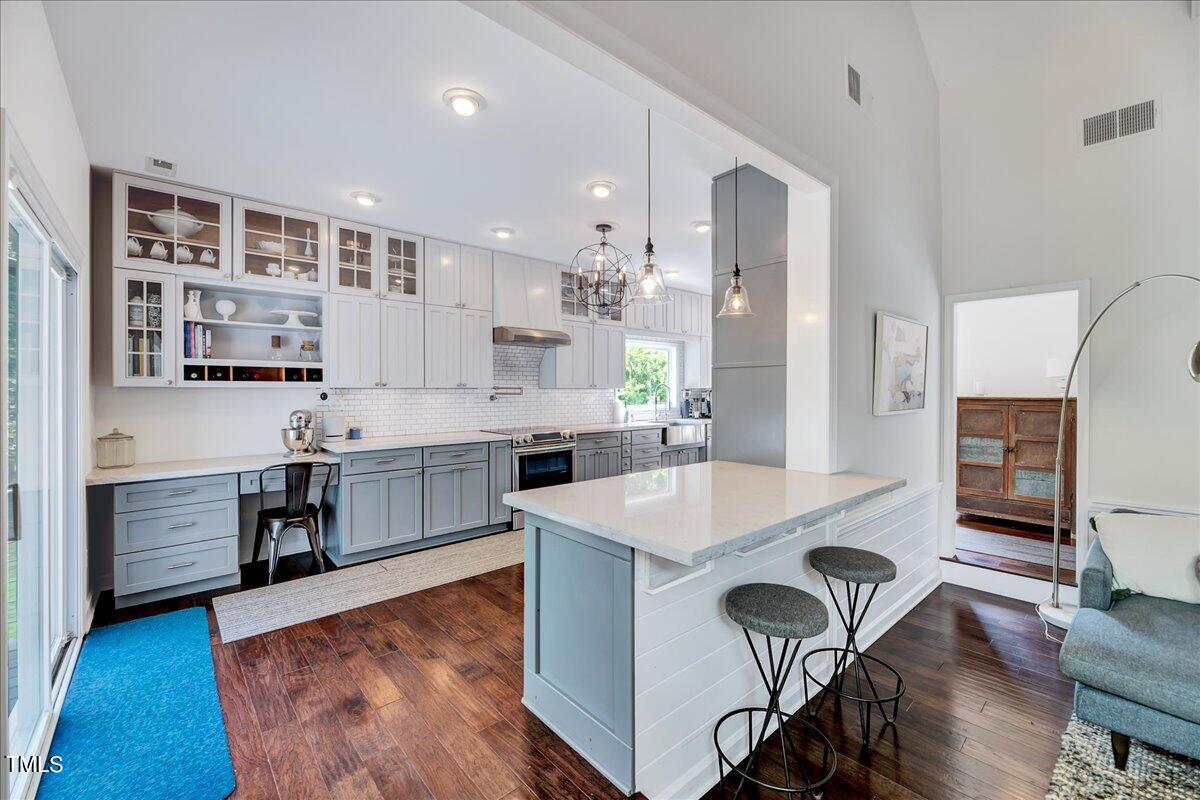 11313 Rumshill Road Raleigh, NC 27614 - Photo 13 of 55 a large kitchen with cabinets wooden floor and stainless steel appliances