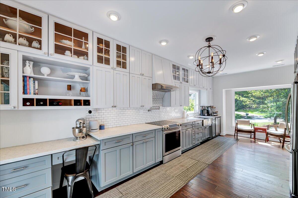 11313 Rumshill Road Raleigh, NC 27614 - Photo 14 of 55 a large kitchen with stainless steel appliances a large center island attached withe living room