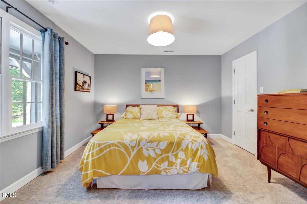 11313 Rumshill Road Raleigh, NC 27614 - Photo 27 of 55 a bedroom with a bed and window