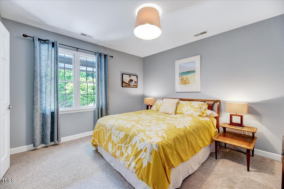 11313 Rumshill Road Raleigh, NC 27614 - Photo 28 of 55 a bedroom with a bed and a large window