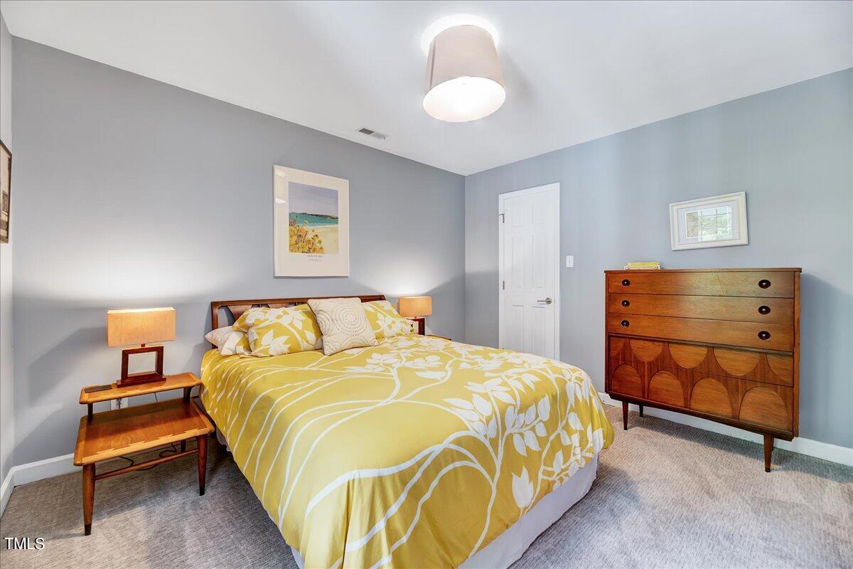 11313 Rumshill Road Raleigh, NC 27614 - Photo 29 of 55 a bedroom with a bed and a dresser