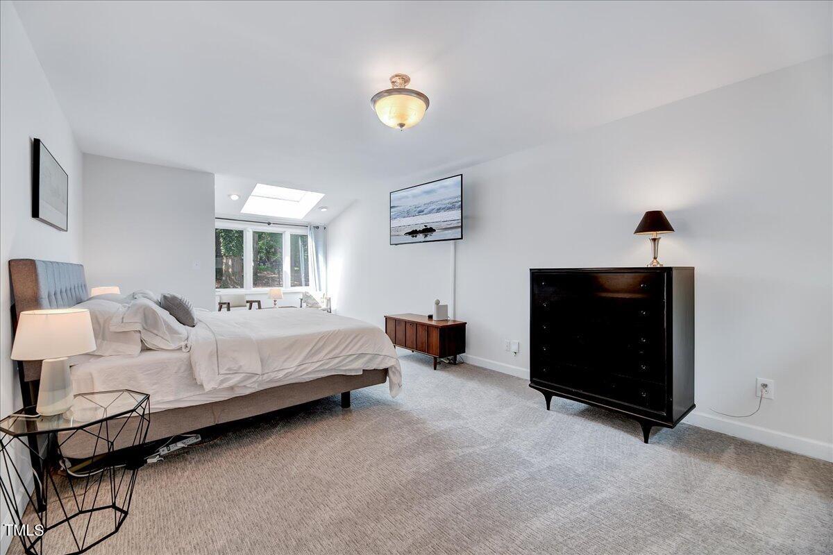 11313 Rumshill Road Raleigh, NC 27614 - Photo 32 of 55 a bed room with a bed and a television