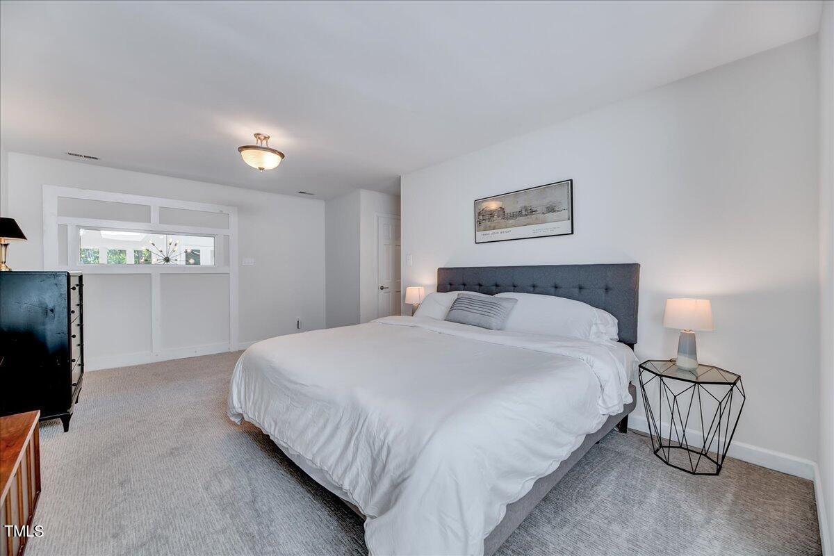 11313 Rumshill Road Raleigh, NC 27614 - Photo 35 of 55 a bedroom with a bed and a painting