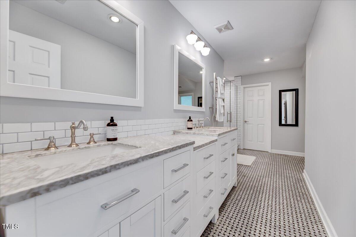 11313 Rumshill Road Raleigh, NC 27614 - Photo 36 of 55 a bathroom with double vanity and a mirror