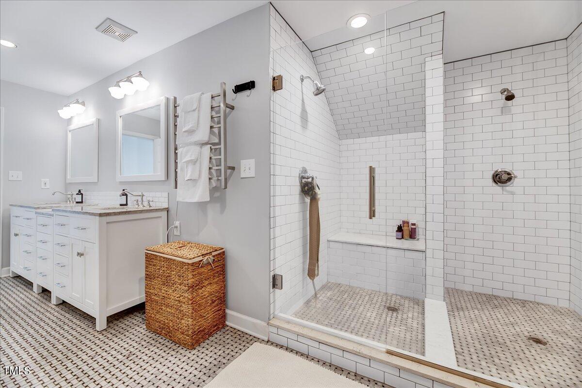 11313 Rumshill Road Raleigh, NC 27614 - Photo 37 of 55 a bathroom with a tub shower vanity and a sink