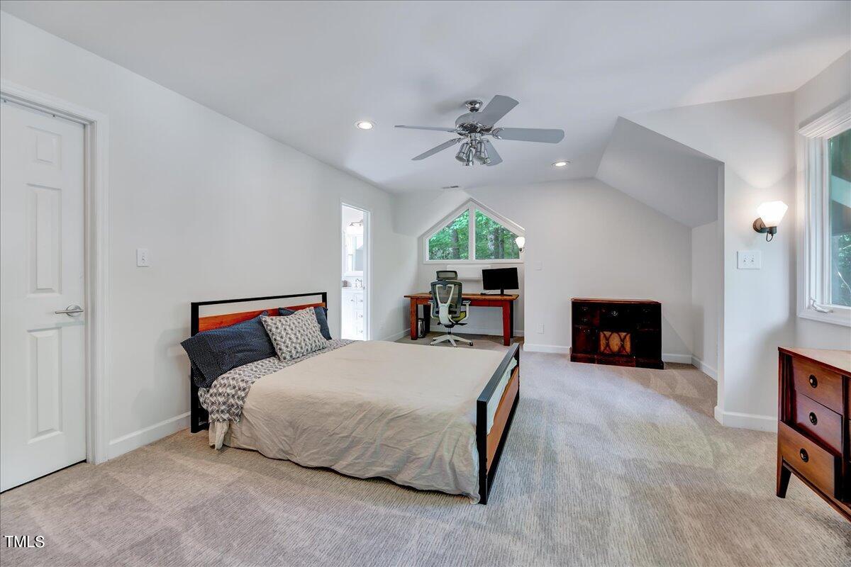 11313 Rumshill Road Raleigh, NC 27614 - Photo 39 of 55 a spacious bedroom with a bed and a fireplace