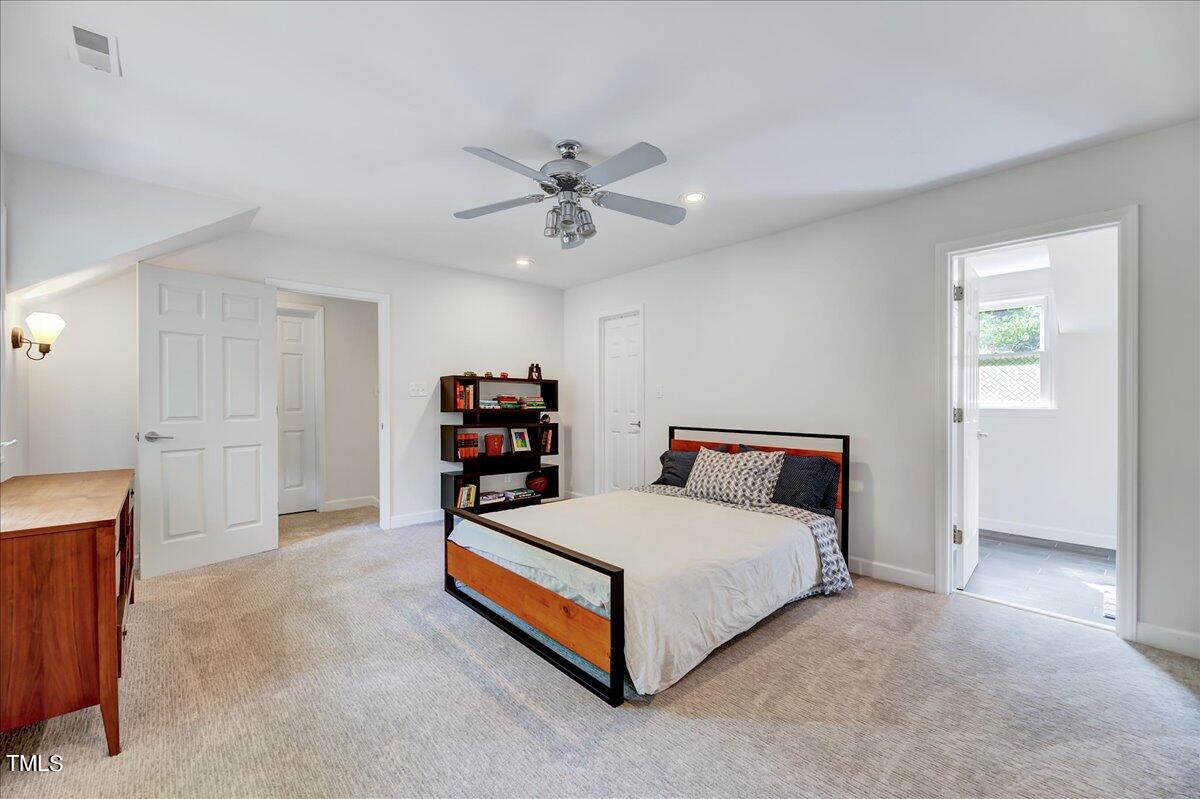 11313 Rumshill Road Raleigh, NC 27614 - Photo 40 of 55 a bedroom with a bed and a chandelier