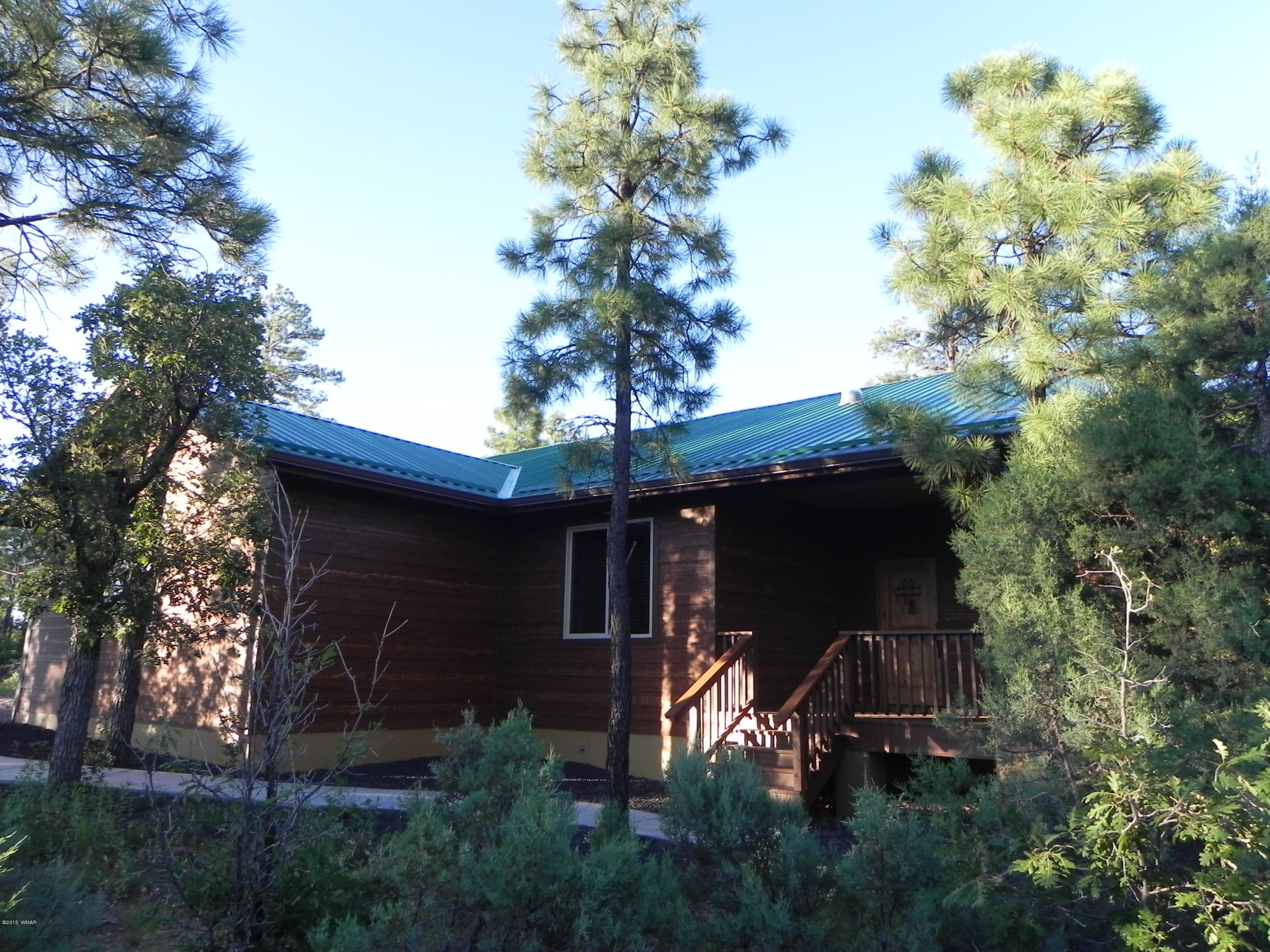 5975 Luminary Way Lakeside, AZ 85929 - Photo 1 of 44 a front view of a house with garden