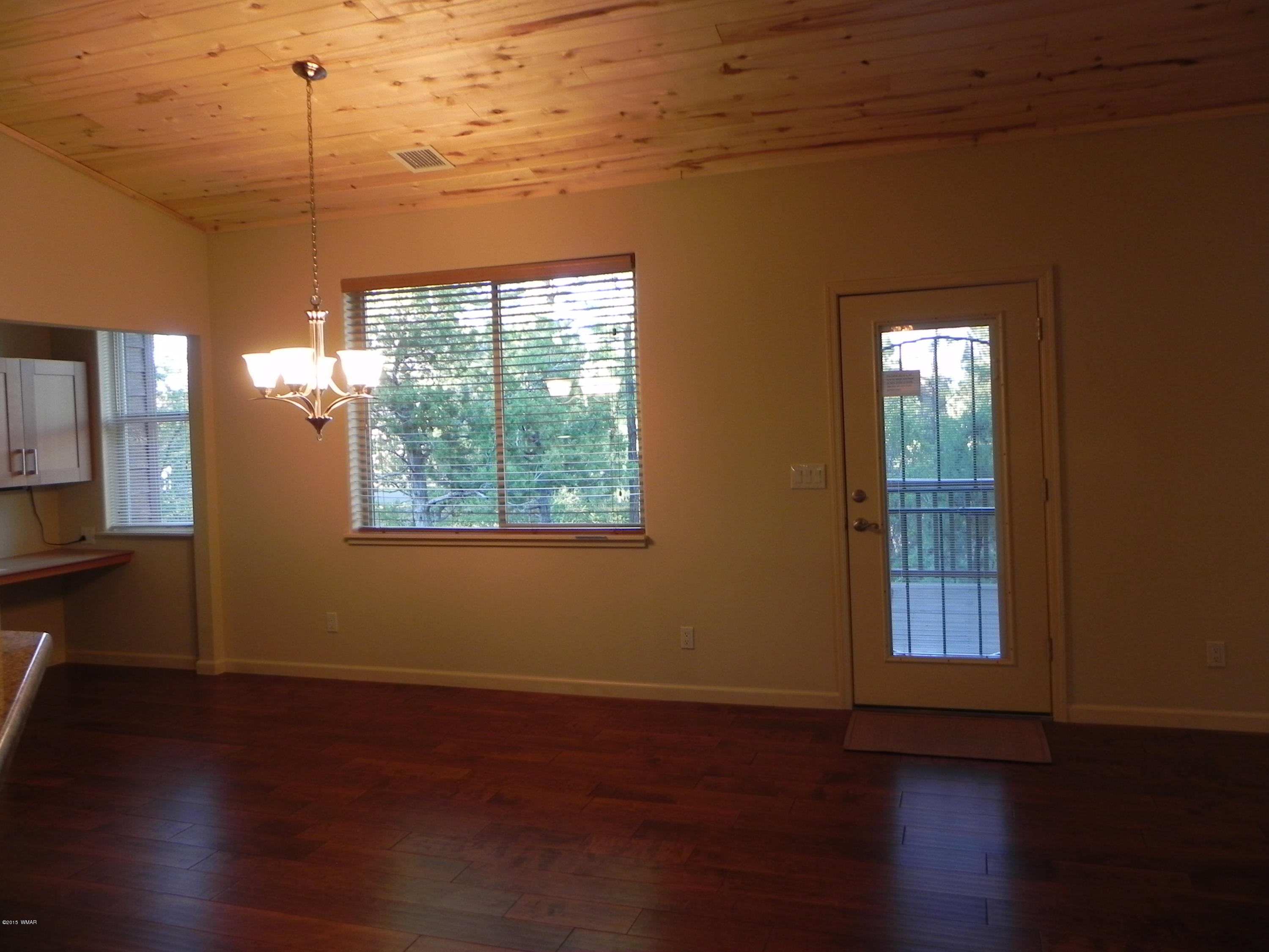 5975 Luminary Way Lakeside, AZ 85929 - Photo 11 of 44 a view of a room with wooden floor and windows
