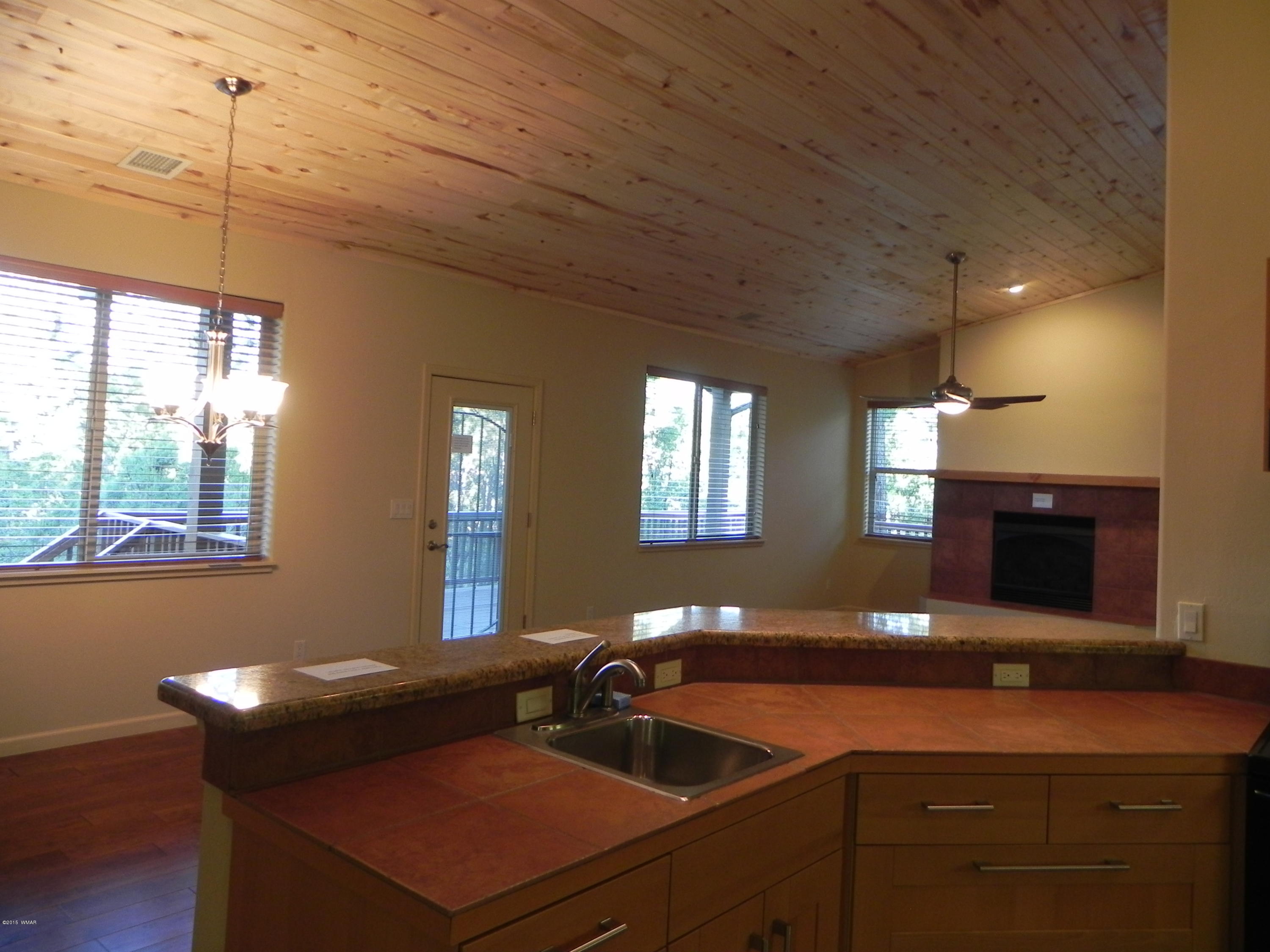 5975 Luminary Way Lakeside, AZ 85929 - Photo 18 of 44 a kitchen with a sink cabinets and window