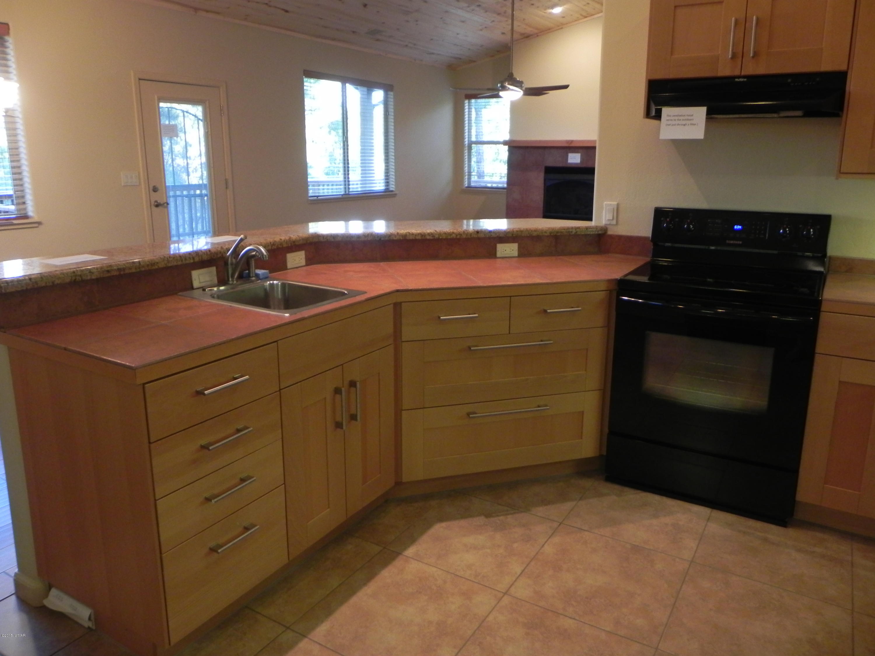 5975 Luminary Way Lakeside, AZ 85929 - Photo 19 of 44 a kitchen with cabinets and window