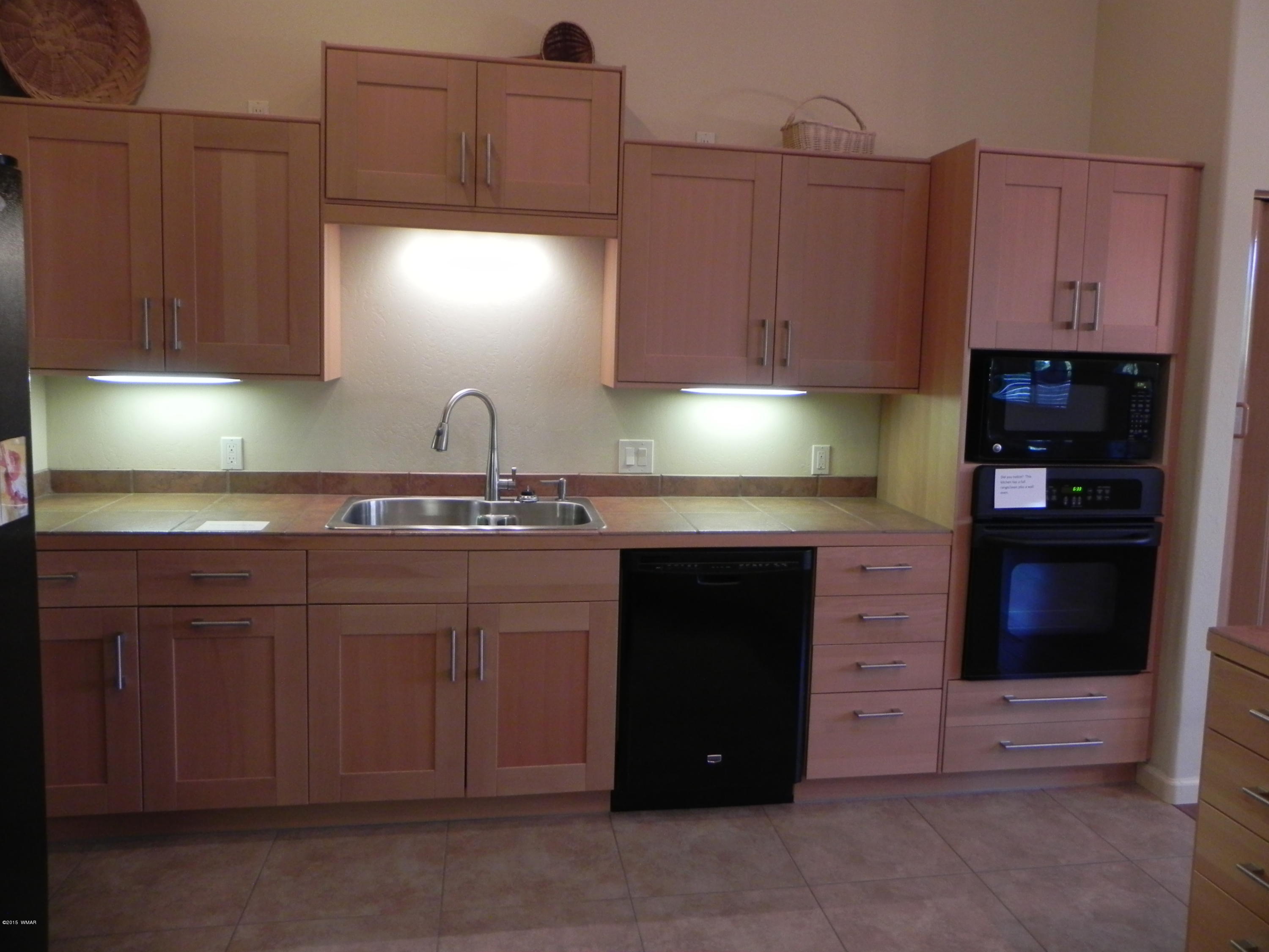 5975 Luminary Way Lakeside, AZ 85929 - Photo 21 of 44 a kitchen with granite countertop a cabinets and a stove