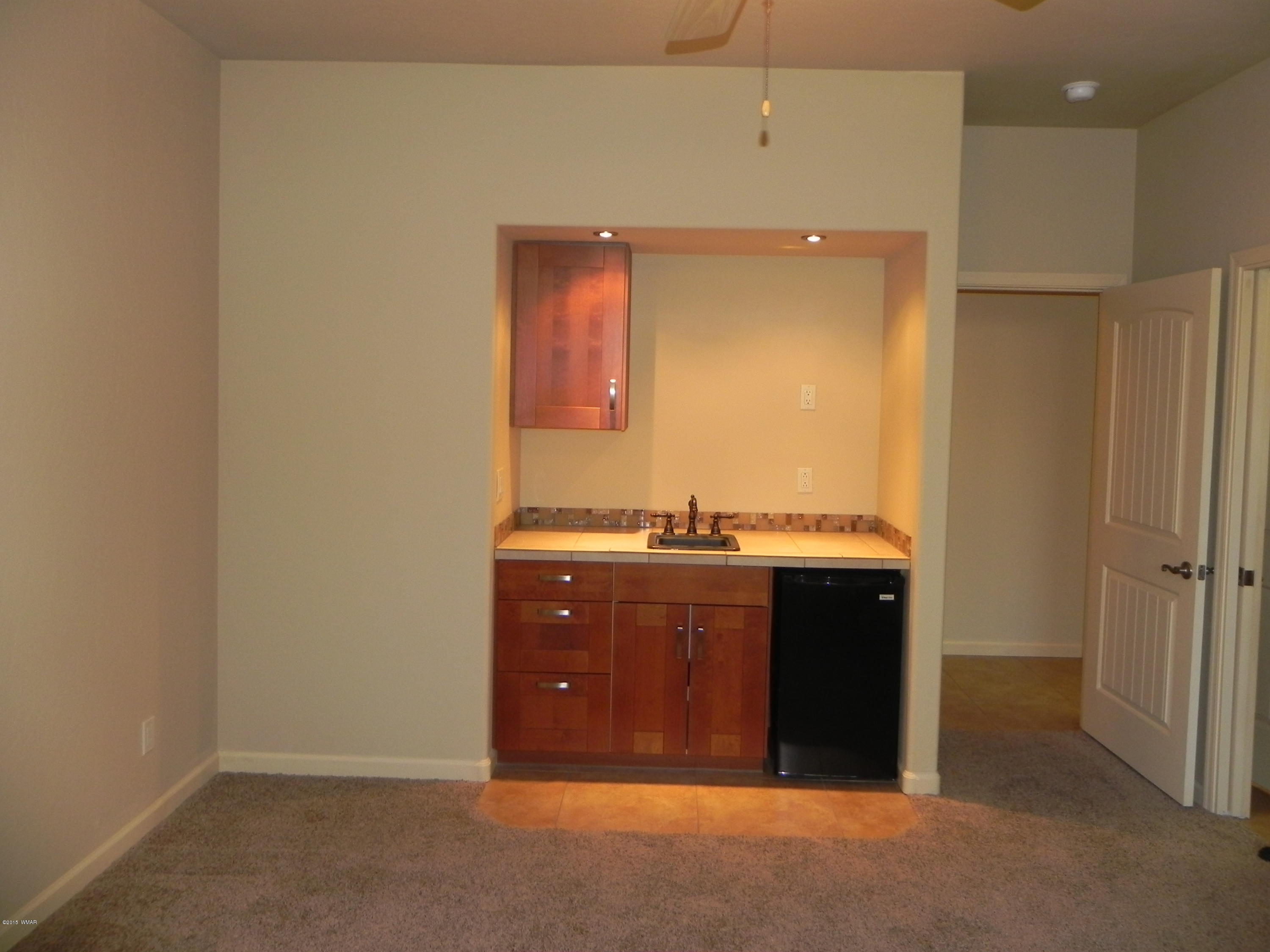5975 Luminary Way Lakeside, AZ 85929 - Photo 23 of 44 an empty room with a sink and mirror