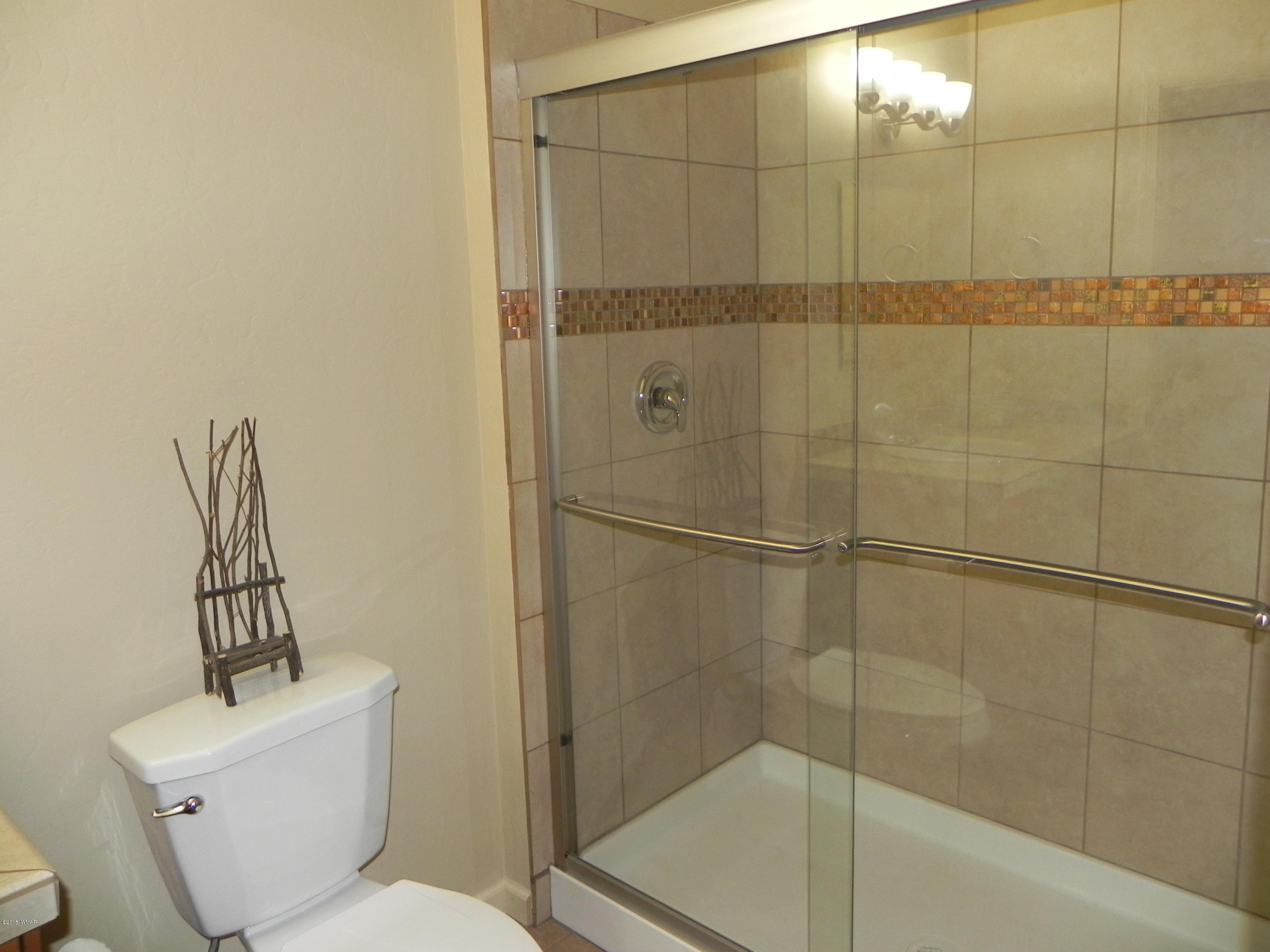 5975 Luminary Way Lakeside, AZ 85929 - Photo 24 of 44 a bathroom with a toilet and a shower