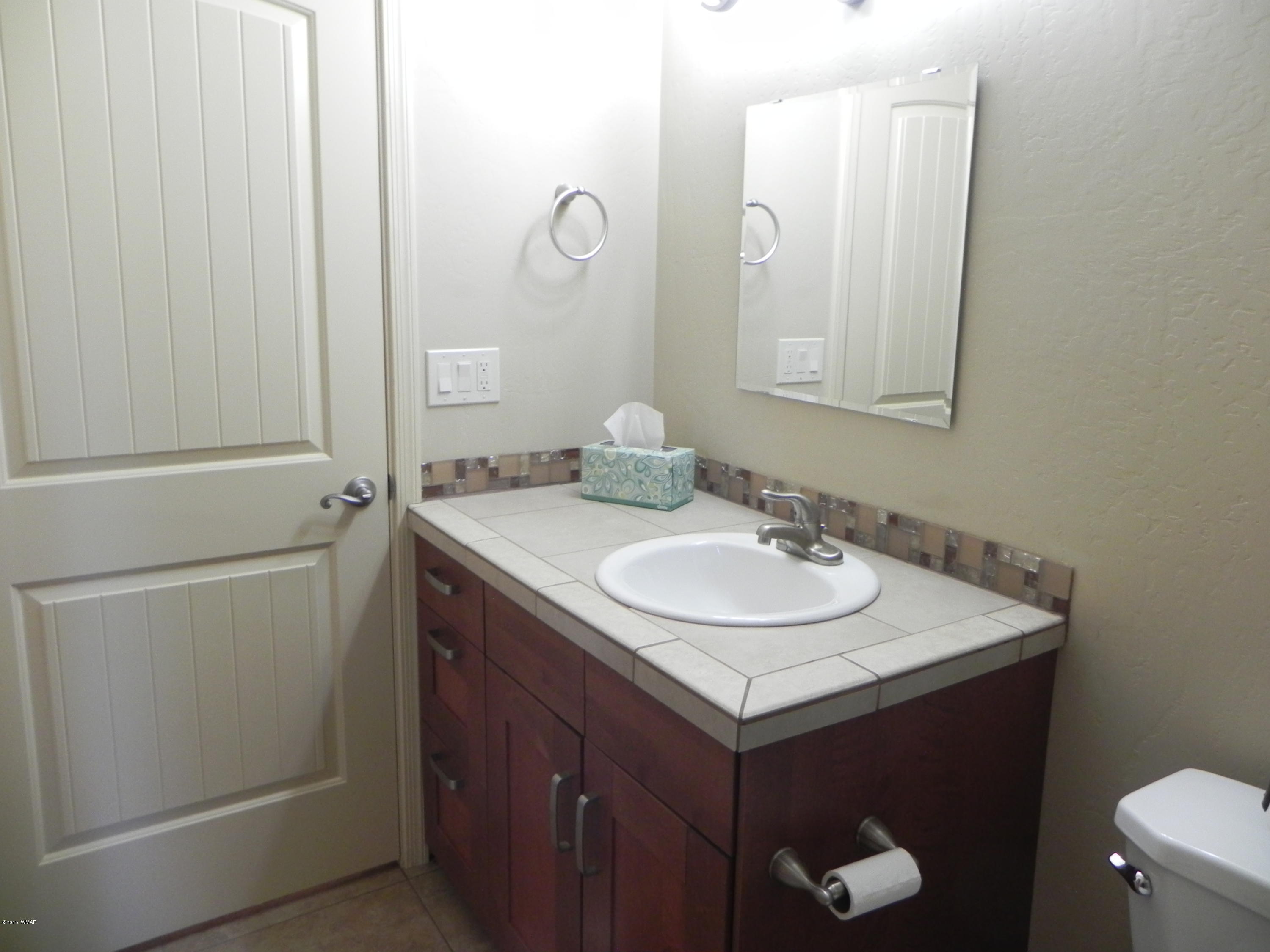 5975 Luminary Way Lakeside, AZ 85929 - Photo 25 of 44 a bathroom with a sink and a mirror