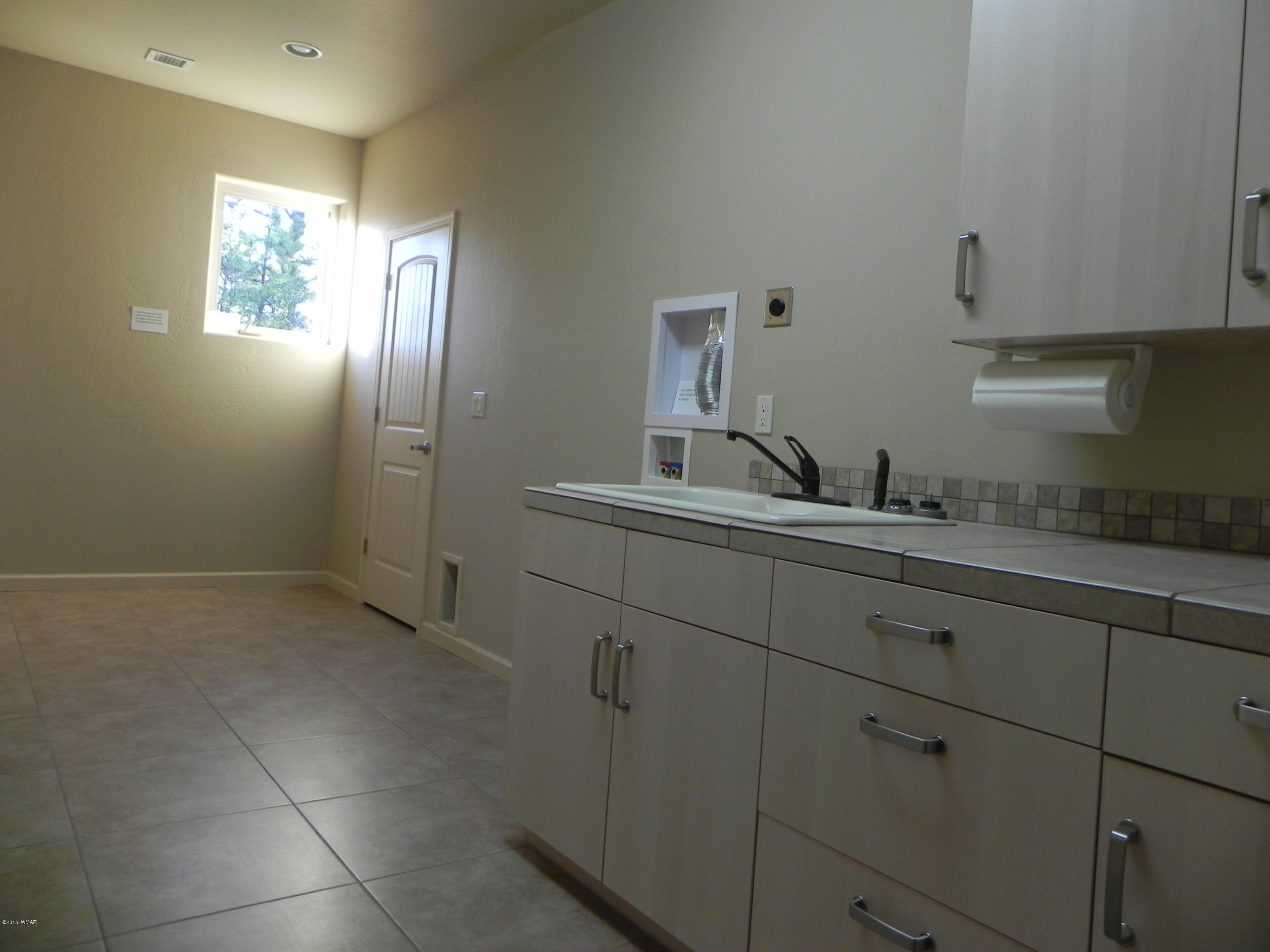 5975 Luminary Way Lakeside, AZ 85929 - Photo 30 of 44 a bathroom with a sink and mirror