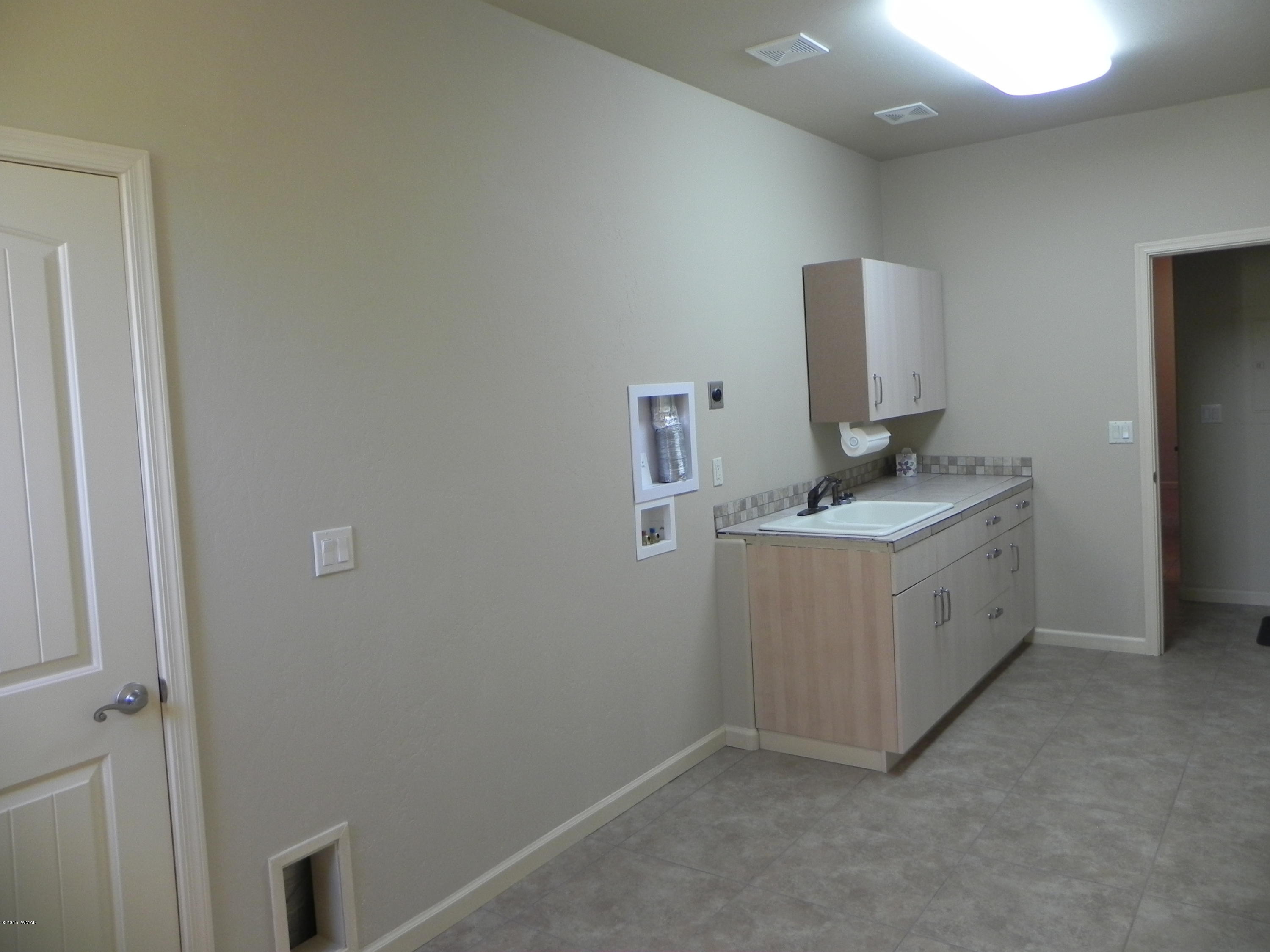 5975 Luminary Way Lakeside, AZ 85929 - Photo 31 of 44 a utility room with sink dryer and washer