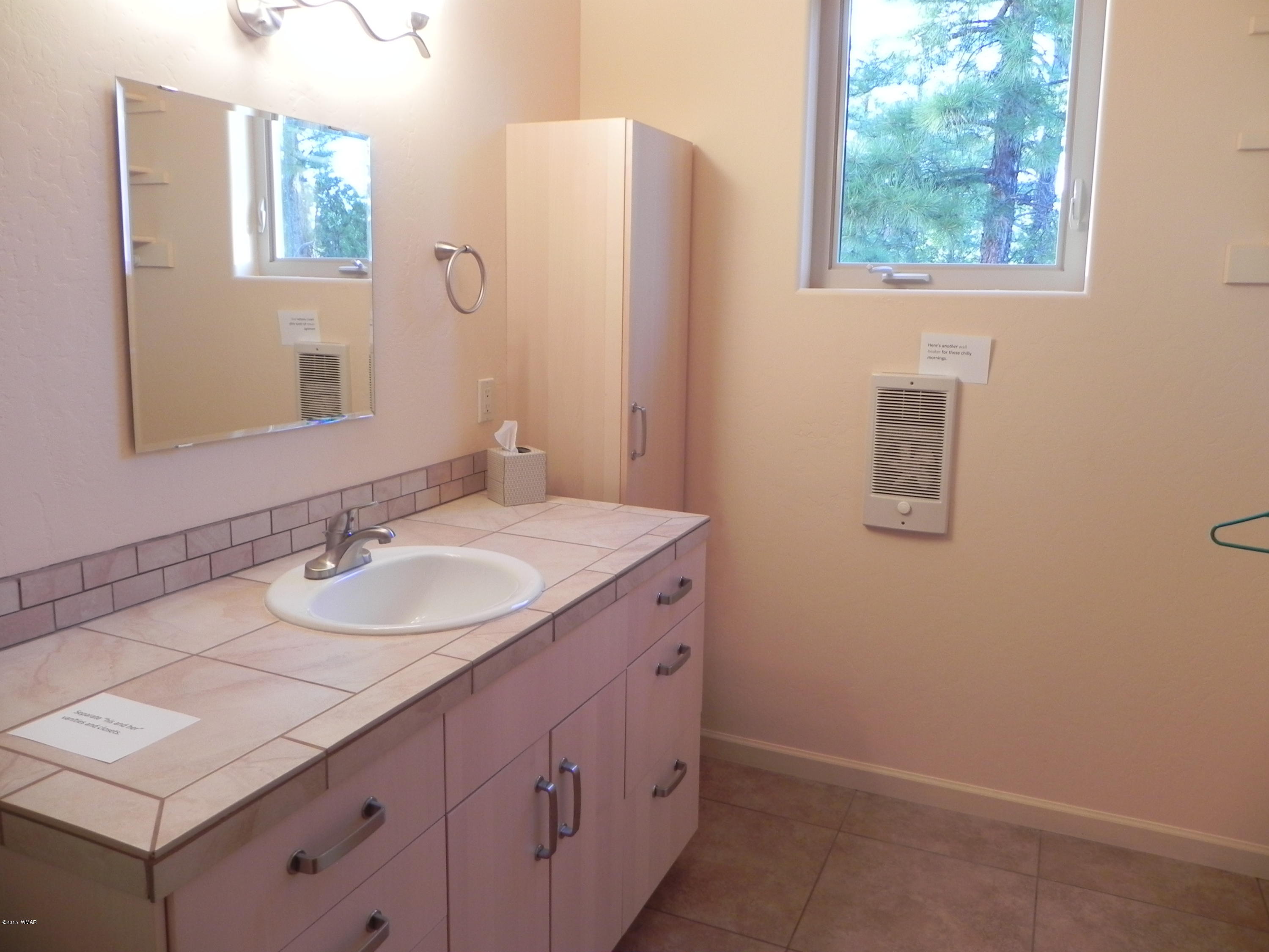 5975 Luminary Way Lakeside, AZ 85929 - Photo 38 of 44 a bathroom with a sink and a mirror