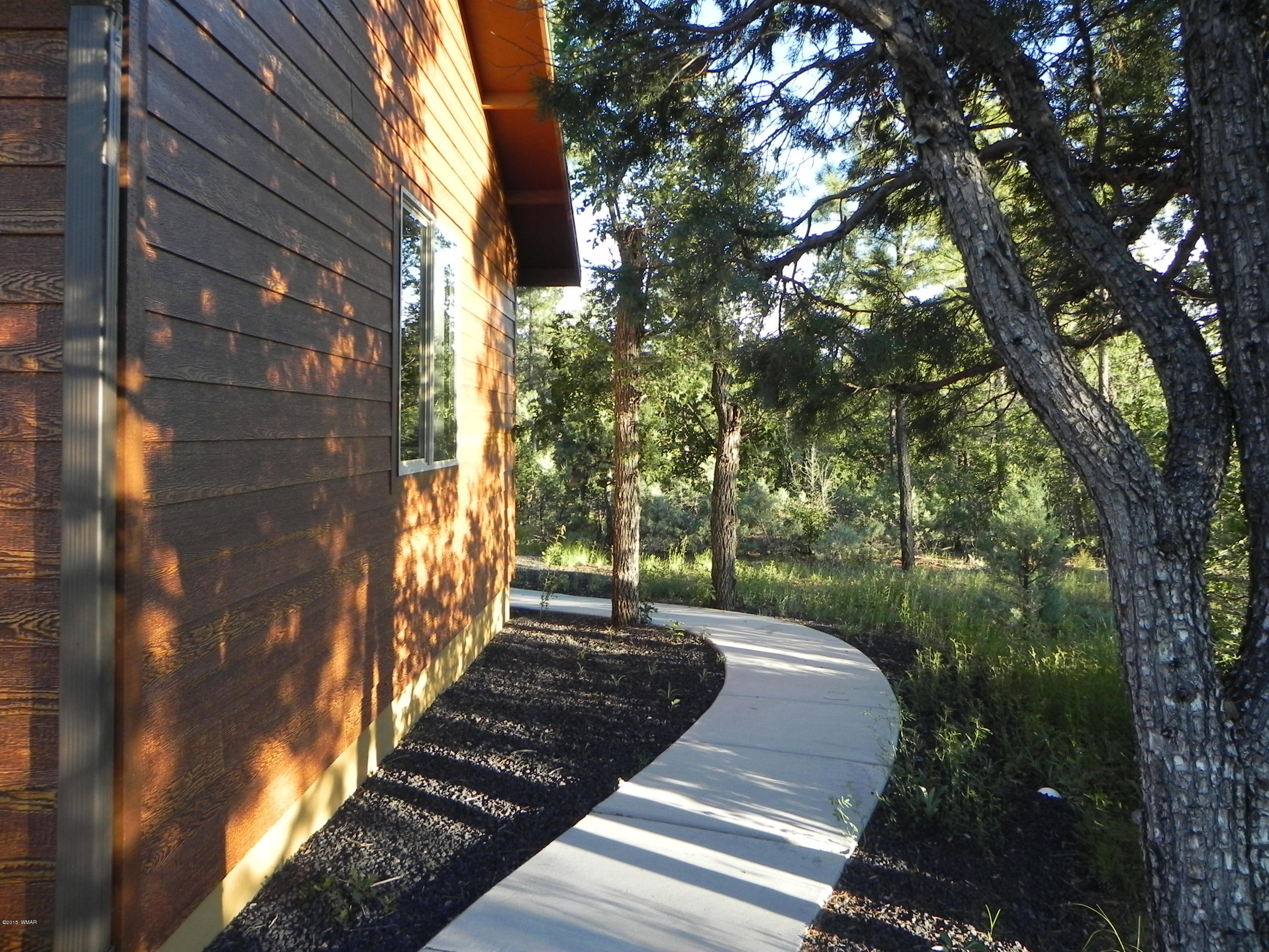 5975 Luminary Way Lakeside, AZ 85929 - Photo 7 of 44 a view of a pathway of a house with a yard