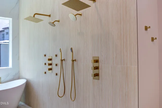 a bathroom with a tub sink and mirror