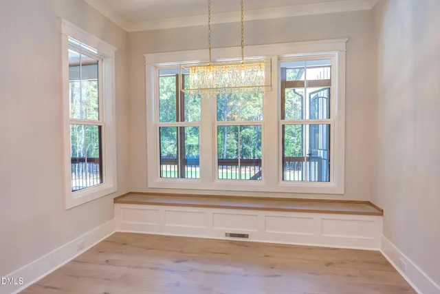 an empty room with a window and a bathroom