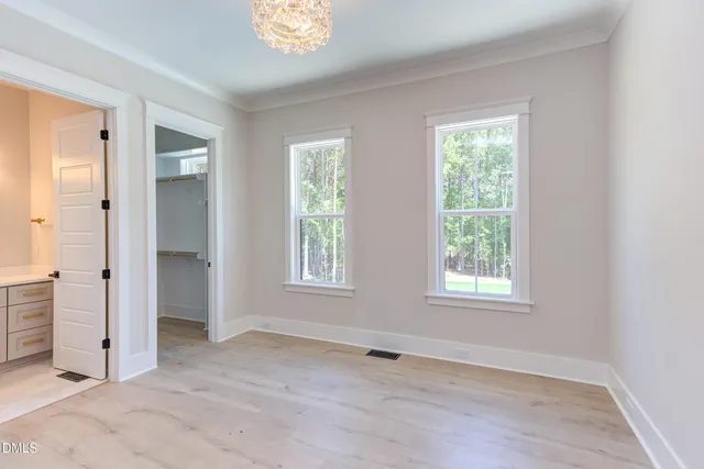 a bathroom with a toilet a sink a vanity and mirror