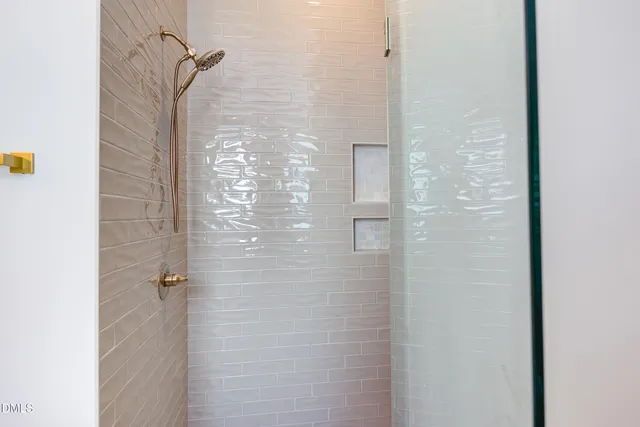 an empty room with window and ceiling fan