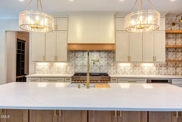 a kitchen with kitchen island granite countertop a sink a window and cabinets