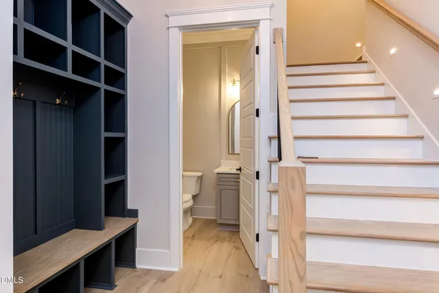 a view of empty room with wooden floor and fireplace