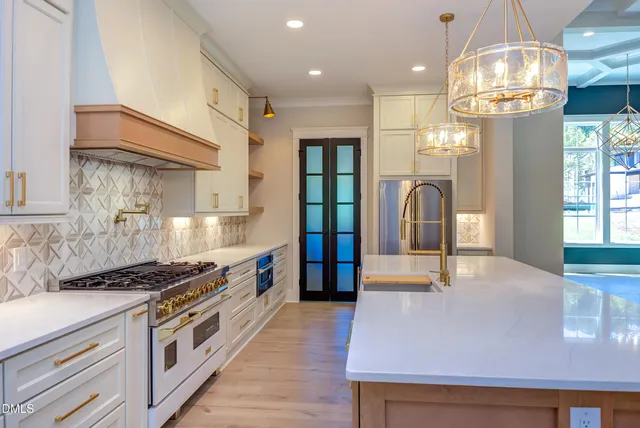 a kitchen with stainless steel appliances granite countertop a stove and a refrigerator