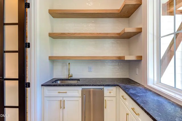a view of a kitchen with a sink and a window