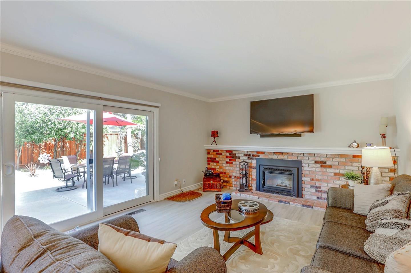 731 West 9th Street Gilroy, CA 95020 - Photo 11 of 37 a living room with furniture a flat screen tv and a fireplace