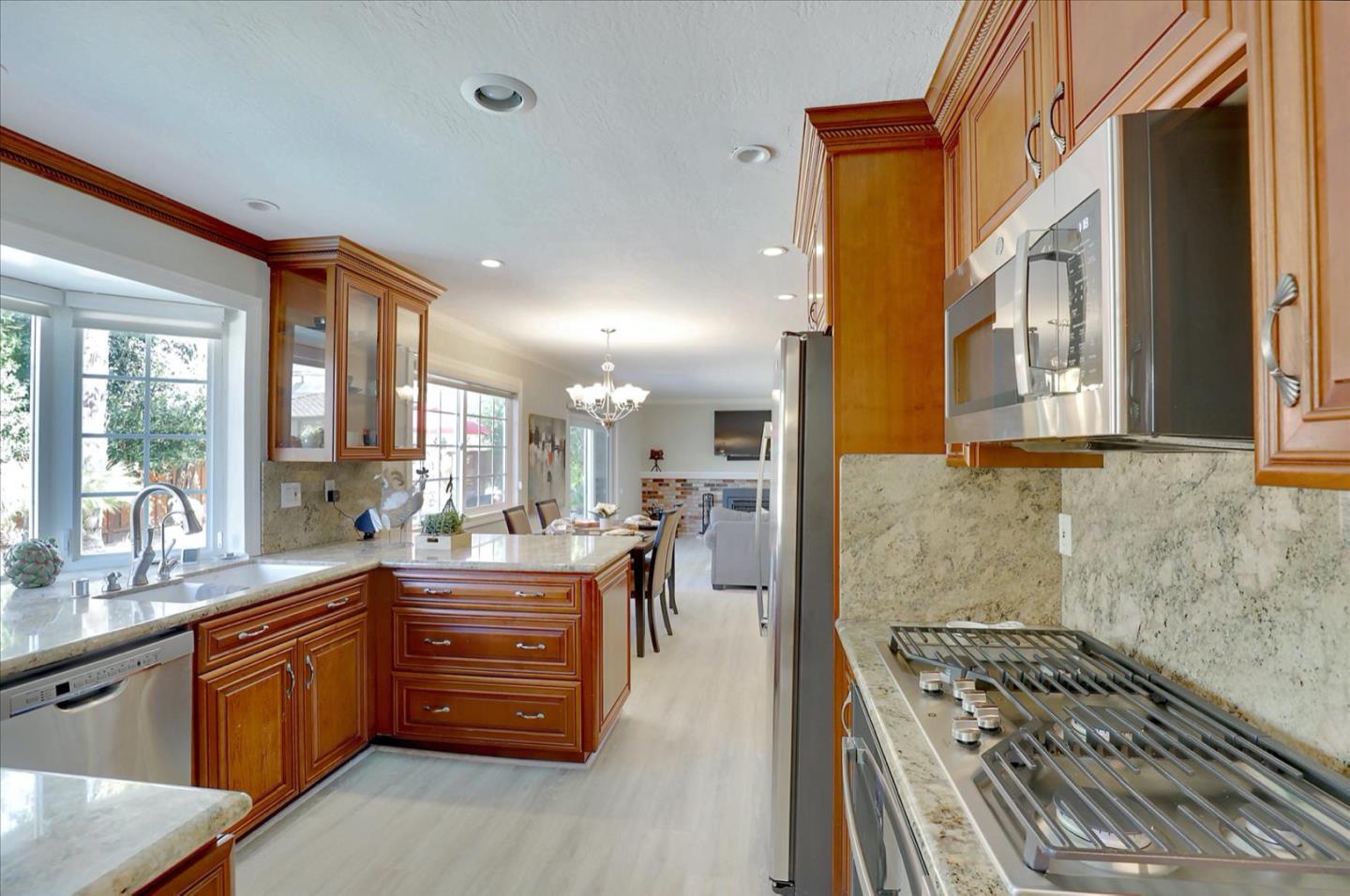 731 West 9th Street Gilroy, CA 95020 - Photo 14 of 37 a large kitchen with stainless steel appliances granite countertop a stove a sink and dishwasher