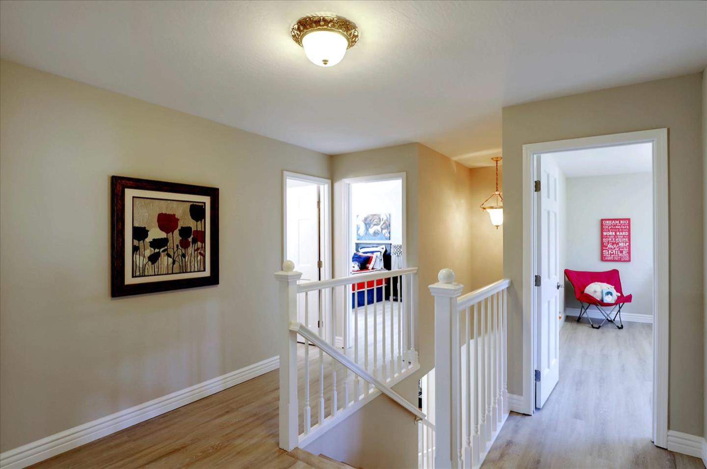731 West 9th Street Gilroy, CA 95020 - Photo 19 of 37 a view of a hallway to a livingroom with wooden floor and windows