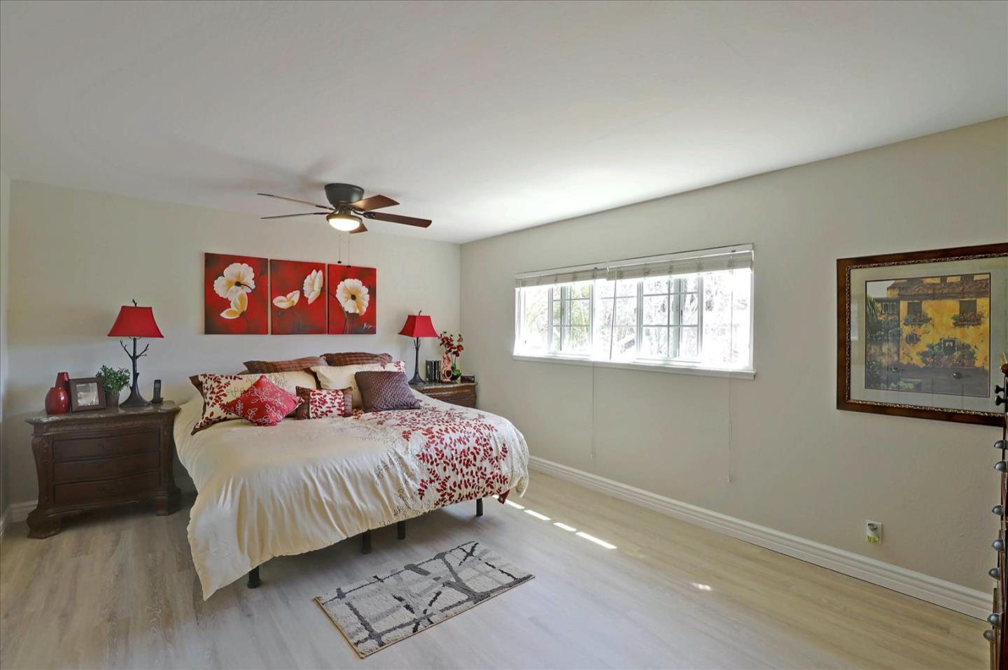 731 West 9th Street Gilroy, CA 95020 - Photo 21 of 37 a bedroom with a bed and a chandelier