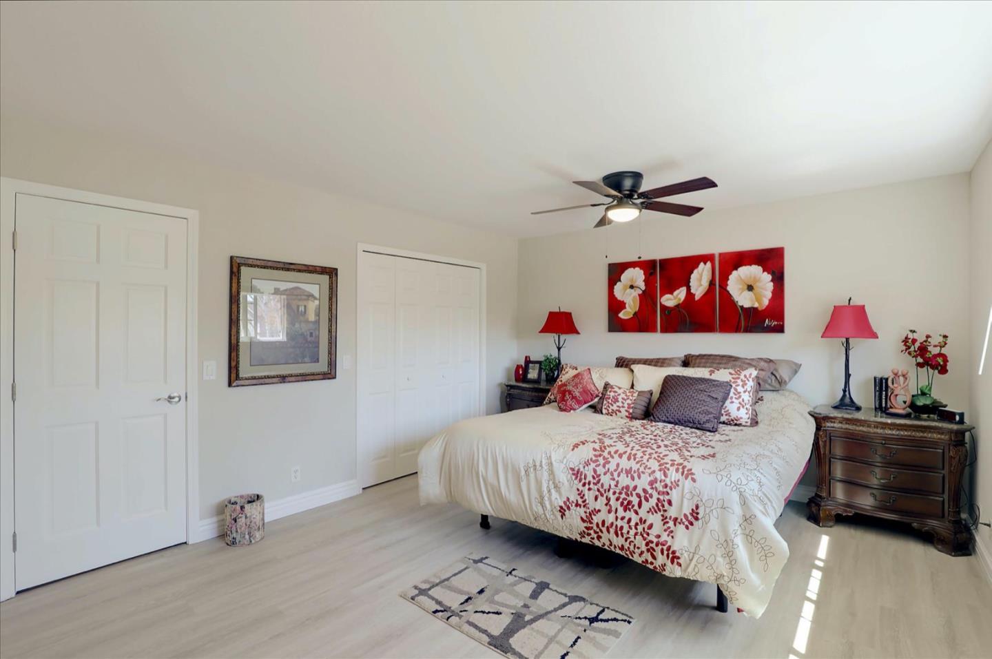 731 West 9th Street Gilroy, CA 95020 - Photo 22 of 37 a bedroom with a bed and a chandelier