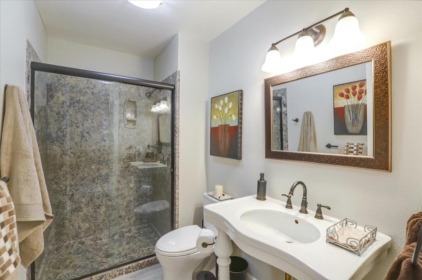 731 West 9th Street Gilroy, CA 95020 - Photo 27 of 37 a bathroom with a sink mirror toilet and shower