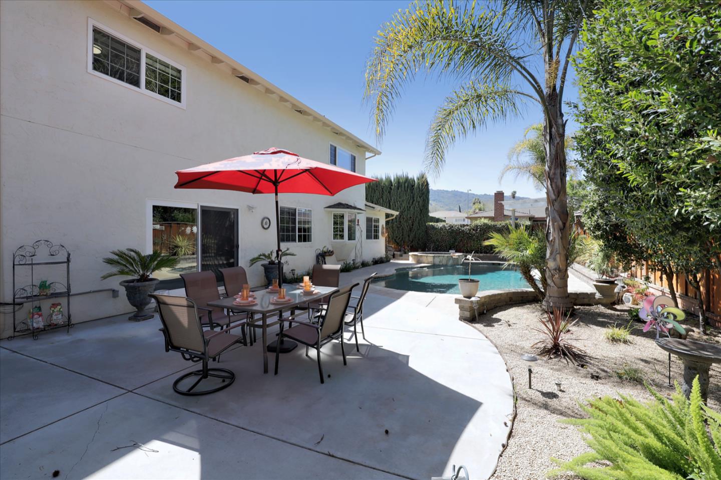731 West 9th Street Gilroy, CA 95020 - Photo 31 of 37 a view of a patio with a dining table and chairs under an umbrella