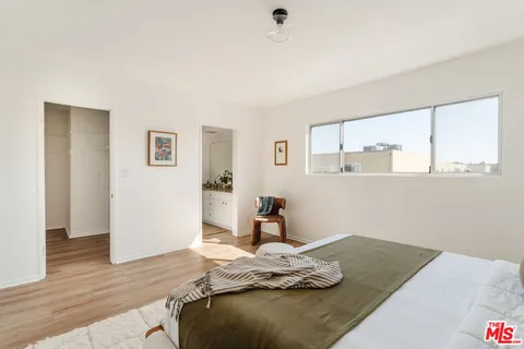 a bedroom with bed and window