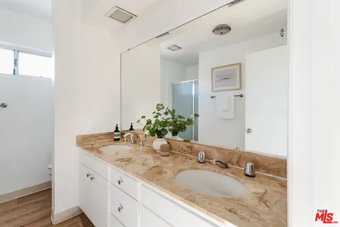 a bathroom with a glass shower door