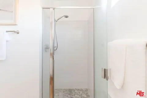 a bedroom with a bed and chair