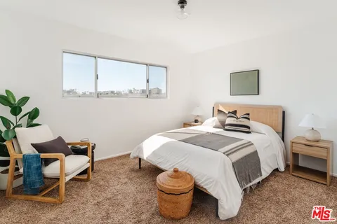 a bedroom with a bed and a mirror