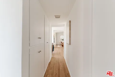 a view of a room with wooden floor and bench